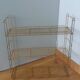 String shelf in golden metal wires
