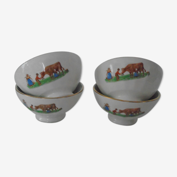 4 old bowls in faience decorate the dairy and her cow