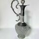 Vintage glass decanter with cut design and silver-plated metal, stopper included.