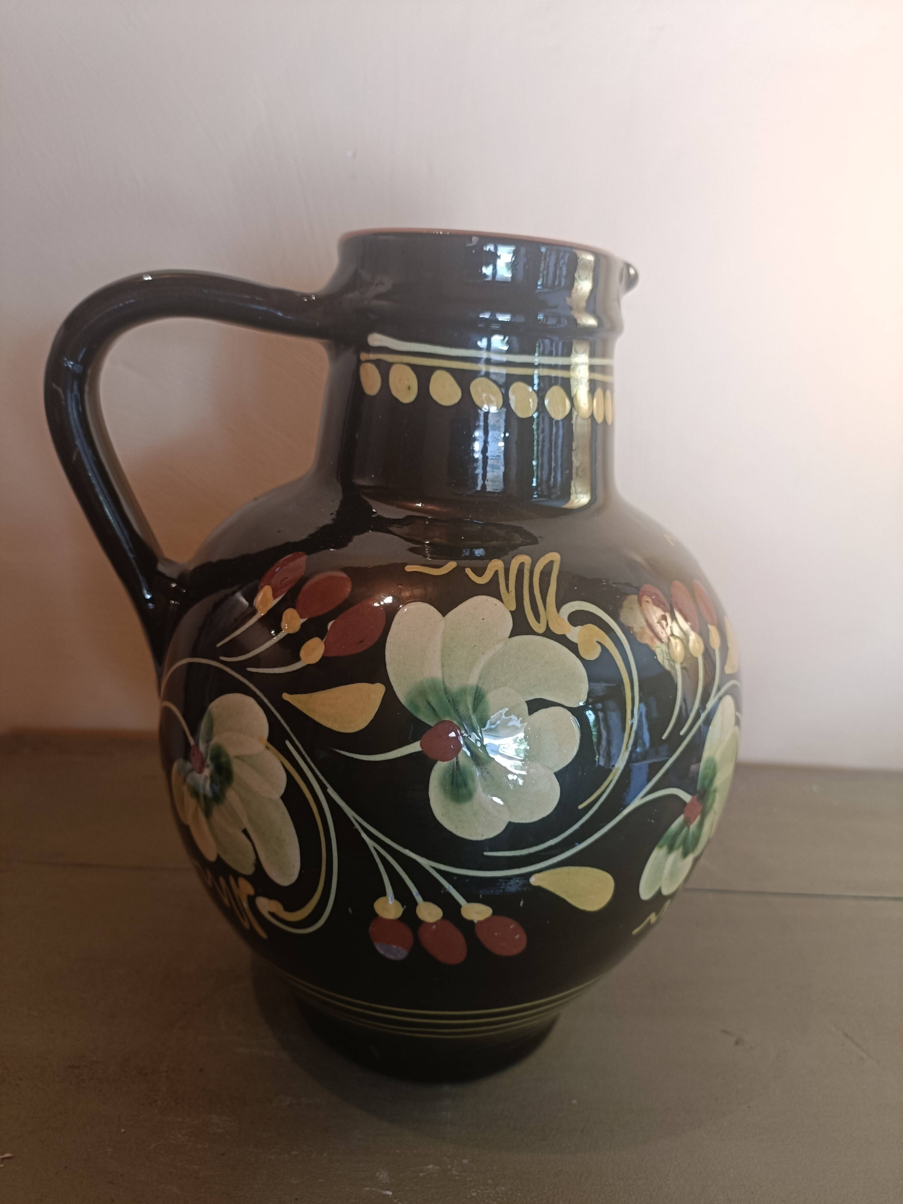Large glazed terracotta pitcher with floral decoration