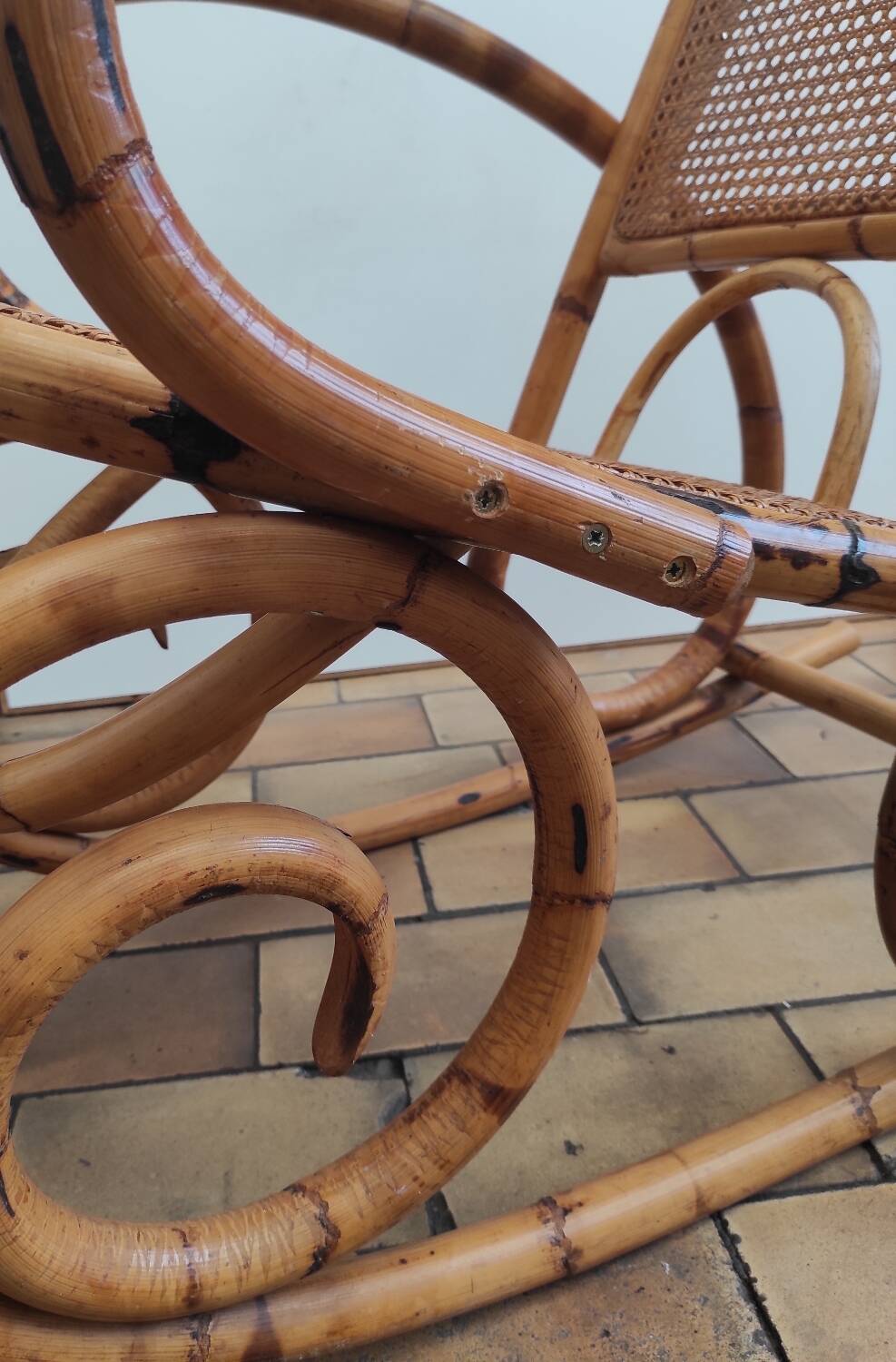 Vintage rocking chair in rattan and cane.