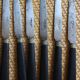 A set of 8 knives with black wooden handles and bolsters.