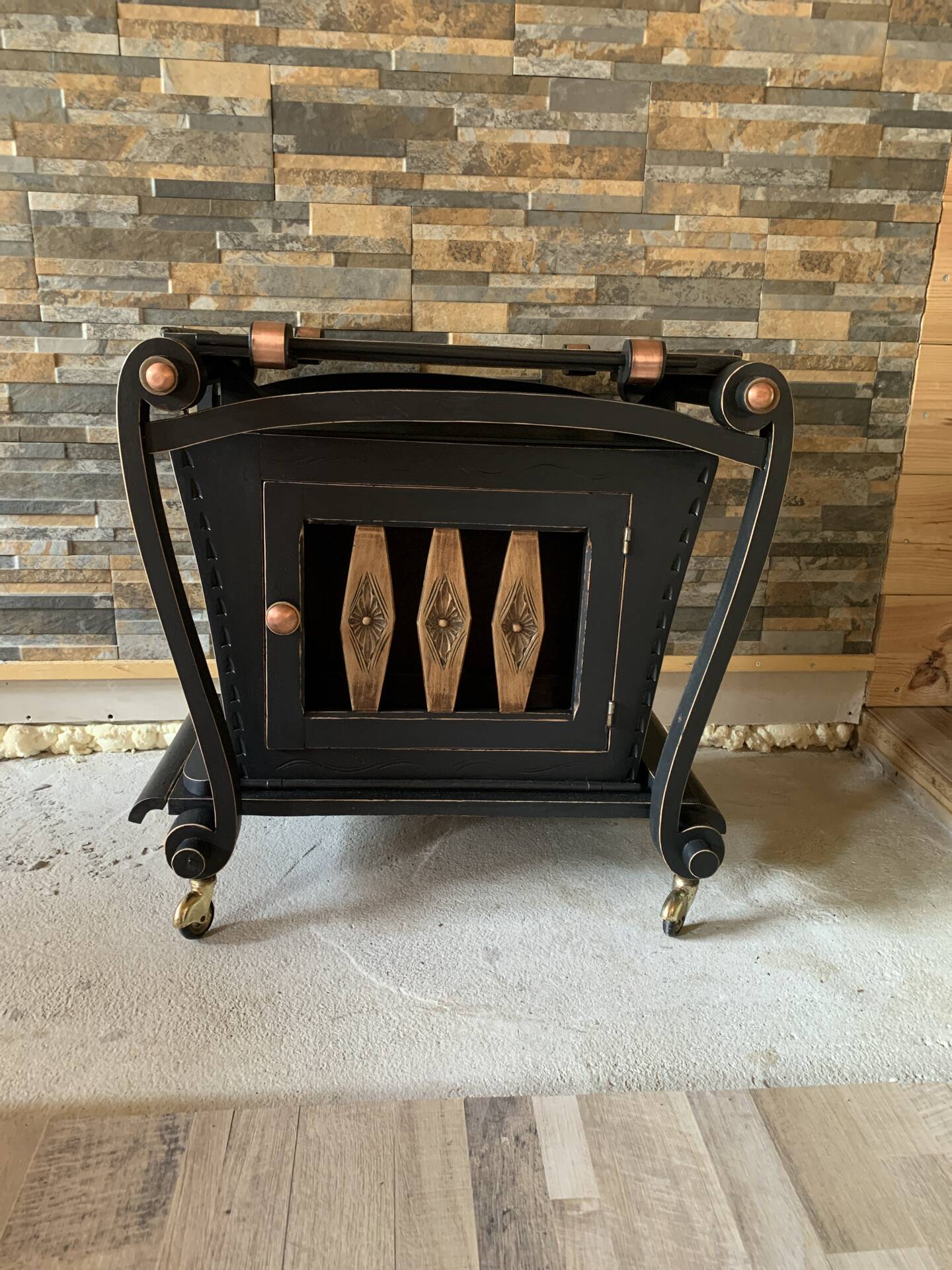 Renovated vintage bar cart in black and copper with removable serving tray.