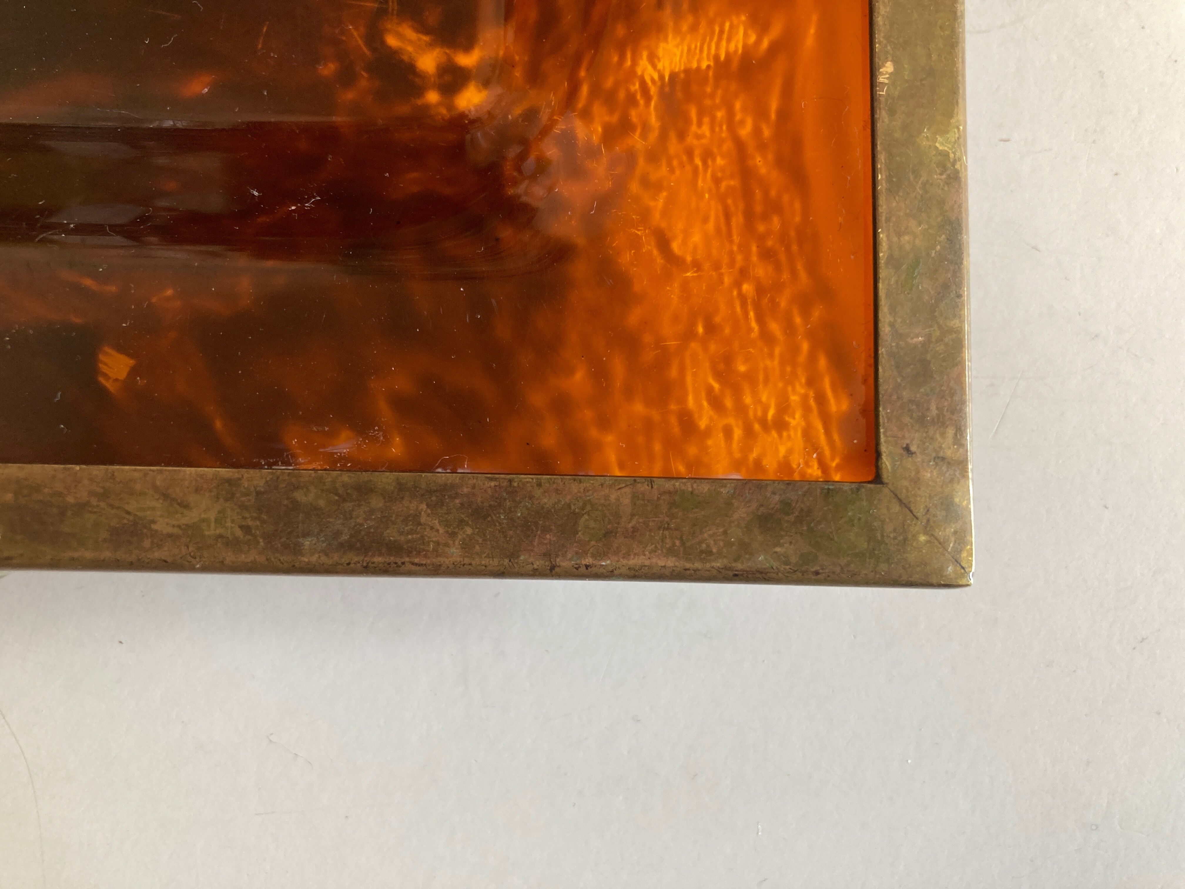 Plate of lucite scale and patinated brass