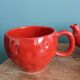 Teapot and cup in the shape of a strawberry.