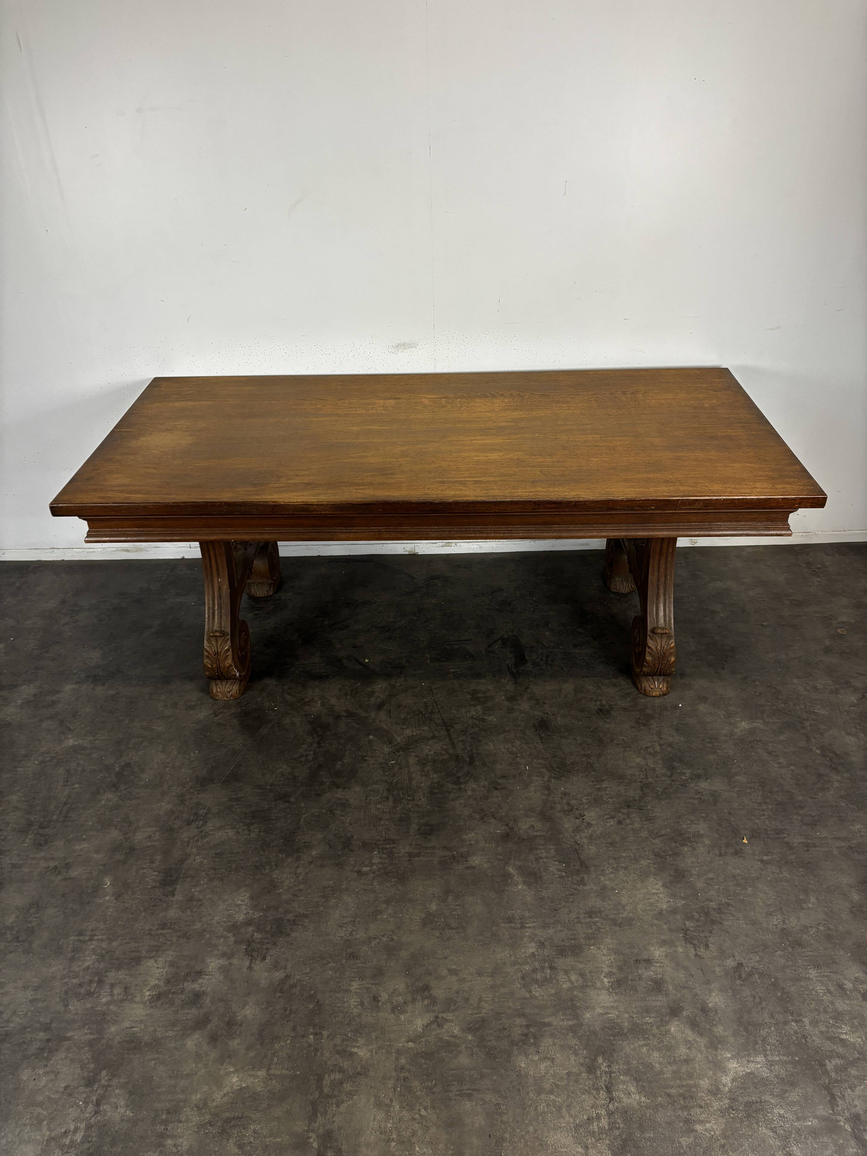 Renaissance-style oak dining table with lyre legs.
