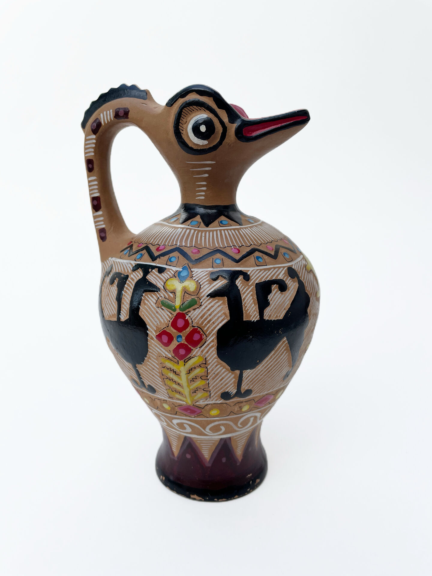 Clay pitcher with a bird head