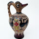 Clay pitcher with a bird head