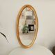 Miroir vintage ovale en bois doré années 60 77*41 cm