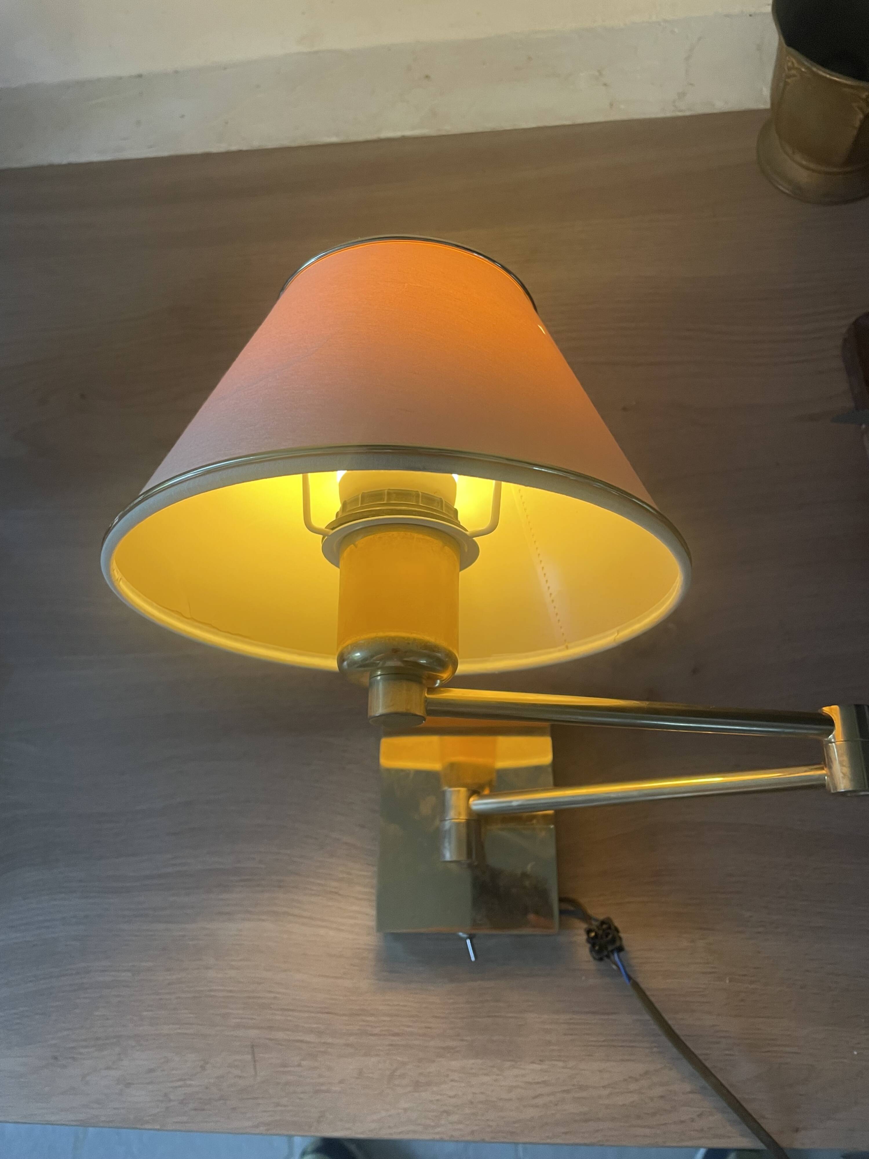 Pair of vintage brass wall lights with adjustable arms.