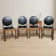 Set of four vintage wooden dining chairs with black leather upholstery, 85 × 45 × 45 cm
