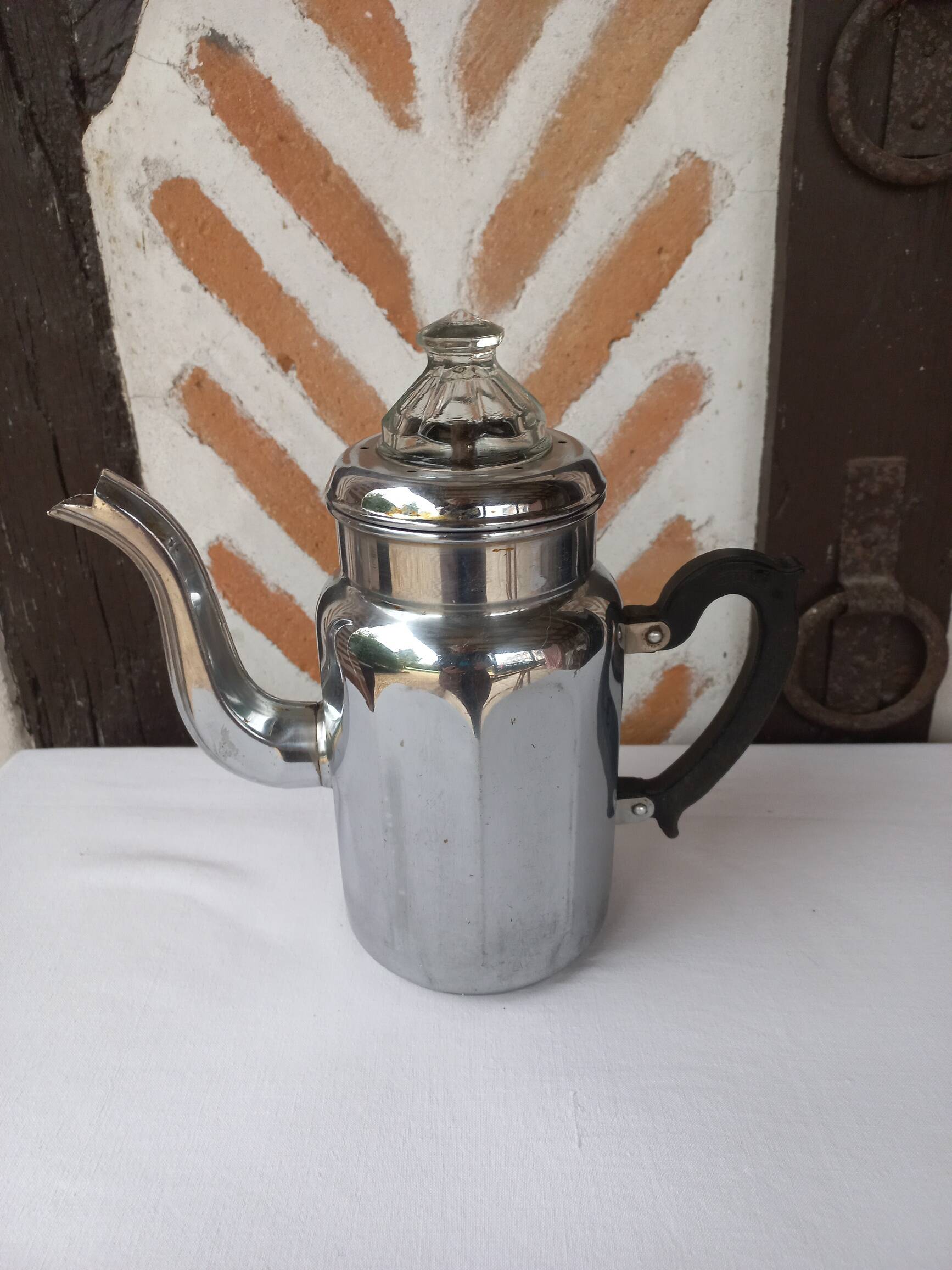 Silver metal coffee maker with glass cap
