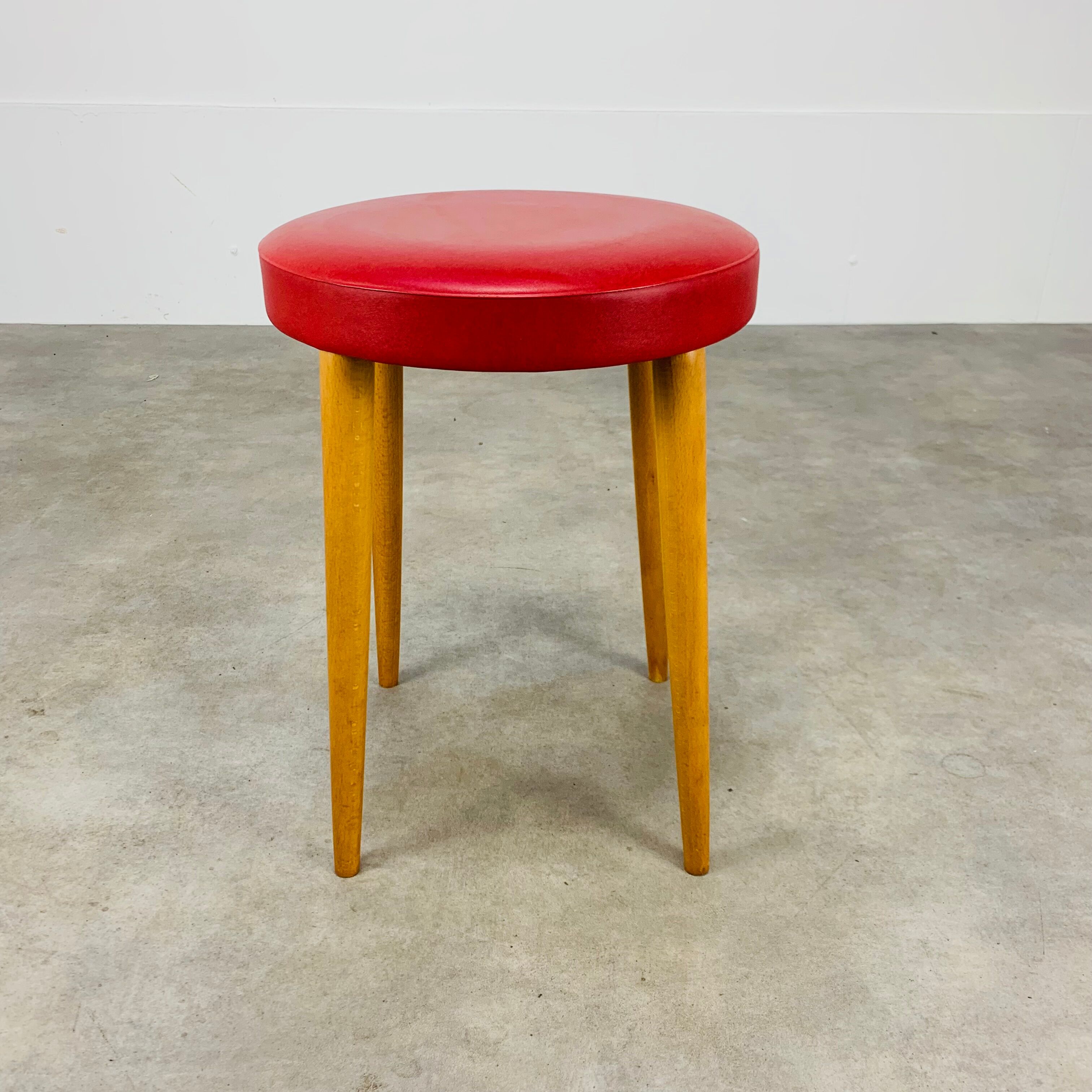 Baumann bistro stool wood and imitation red leather 60s