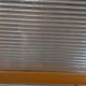 1950s coat rack with mirror, metal hooks, and glass shelf.