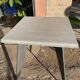 Pedestal table with airplane wing legs