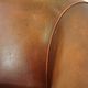 Neat, elegantly finished, cozy sheepskin club armchair with a fixed seat cushion