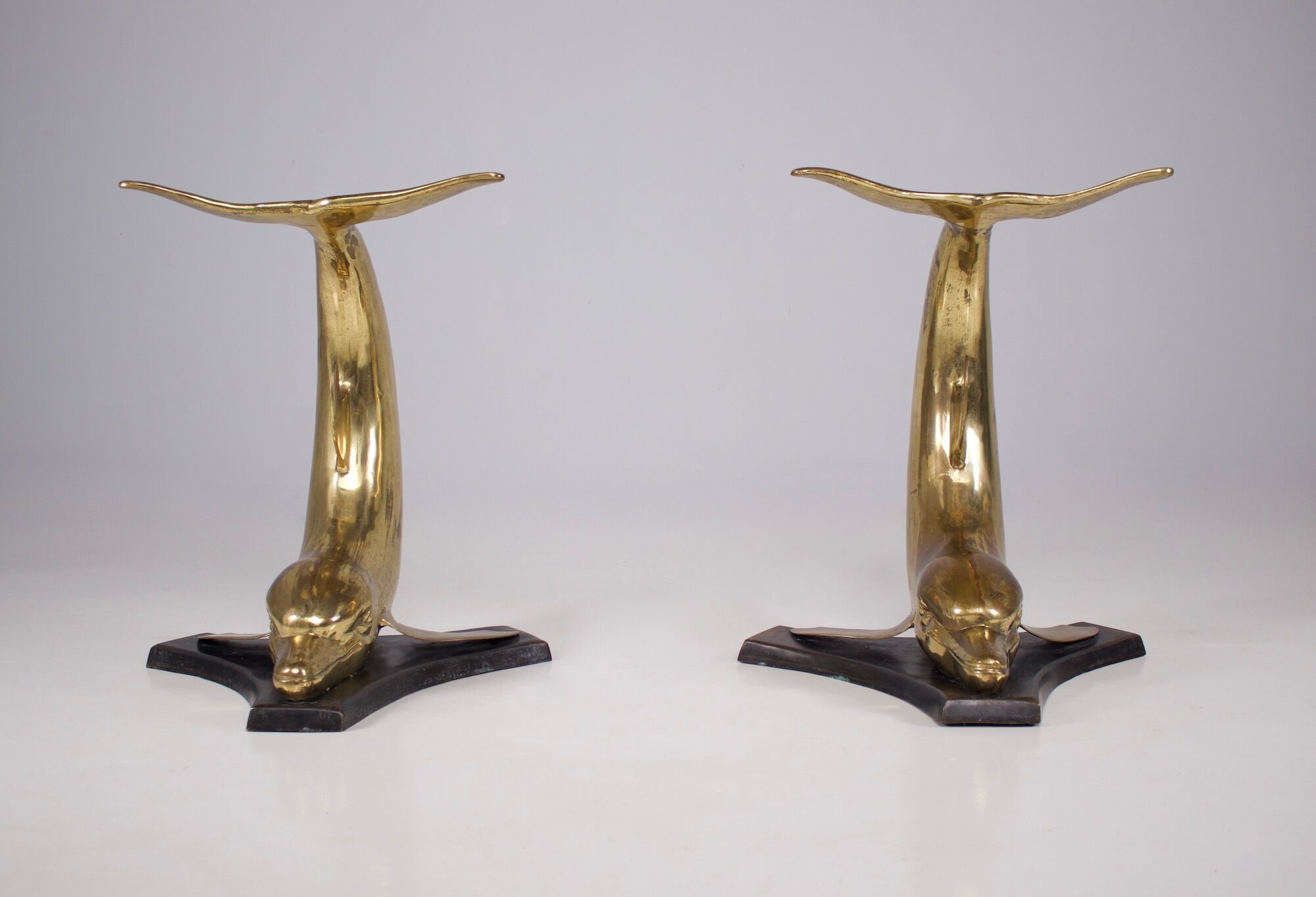 Solid brass dolphin console feet.