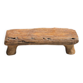 Small stool, footrest in blond teak, organic monoxyle with cut corners.