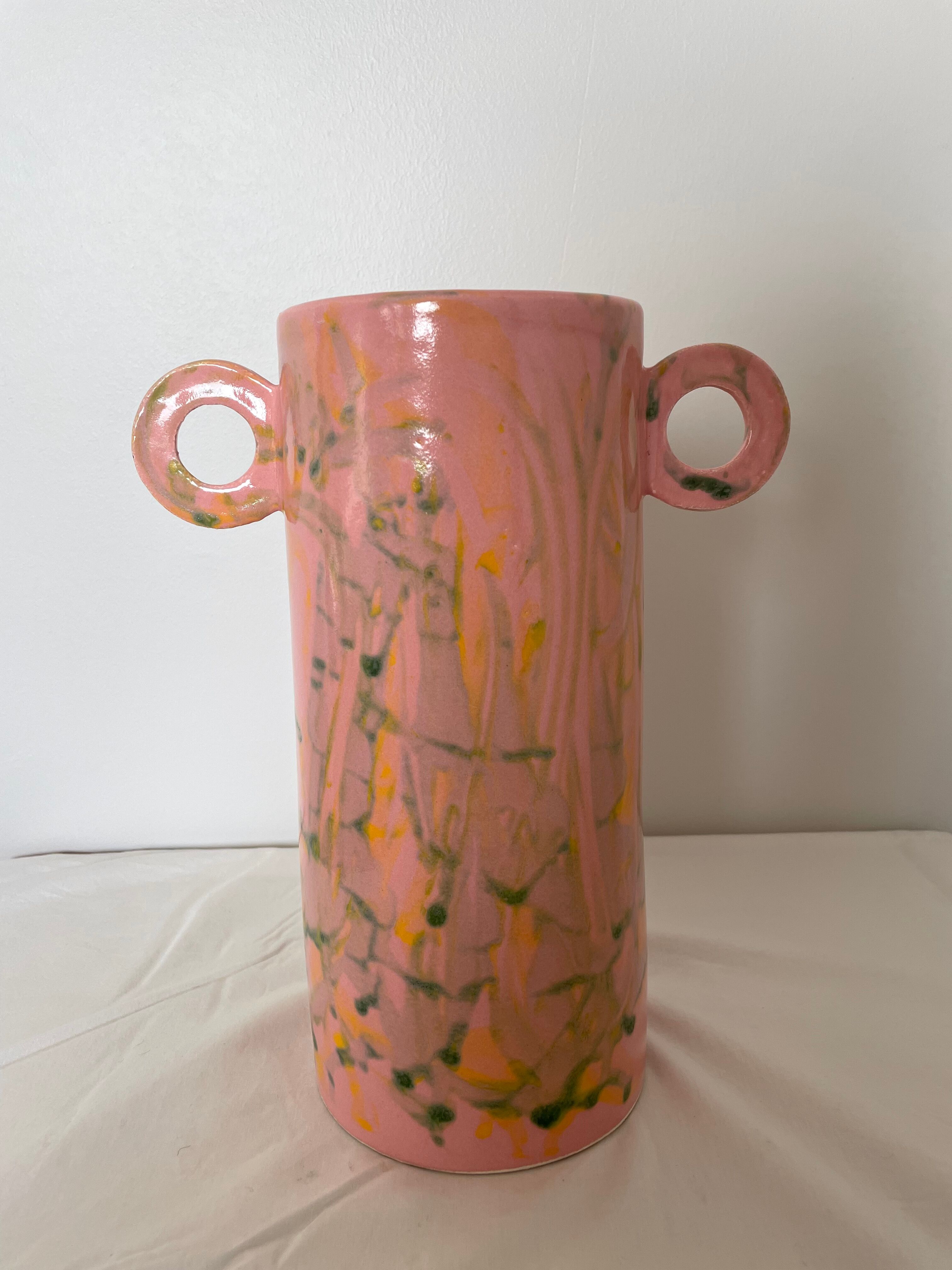Pink ceramic vase with abstract circular handles