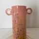 Pink ceramic vase with abstract circular handles