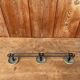 Vintage yellow metal wall coat rack