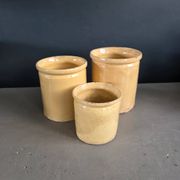 Trio of ancient pots in yellow glazed terracotta.