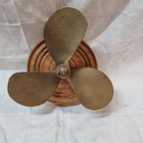 Bronze boat propeller on wood