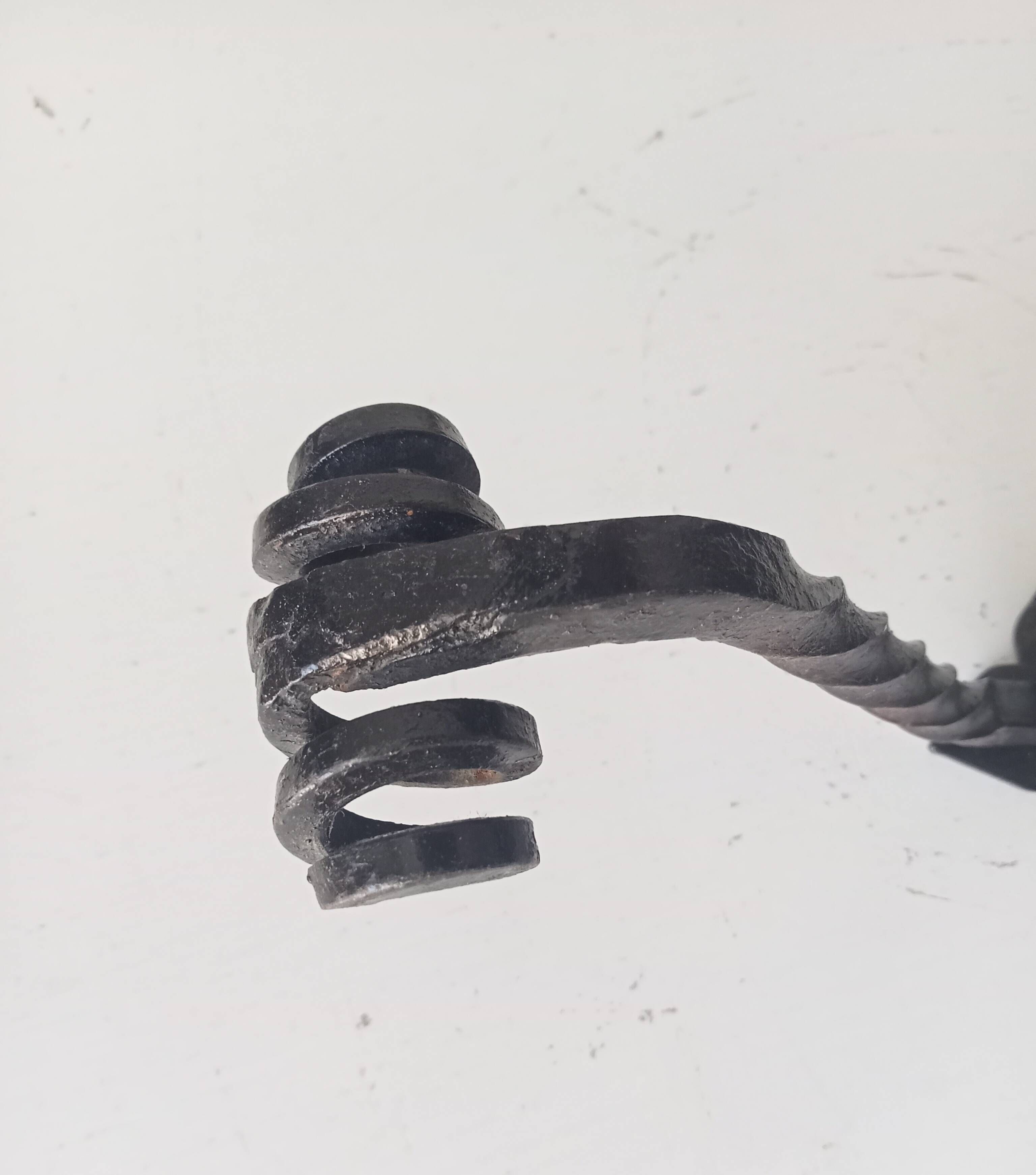 Brutalist wall coat rack in wrought iron.