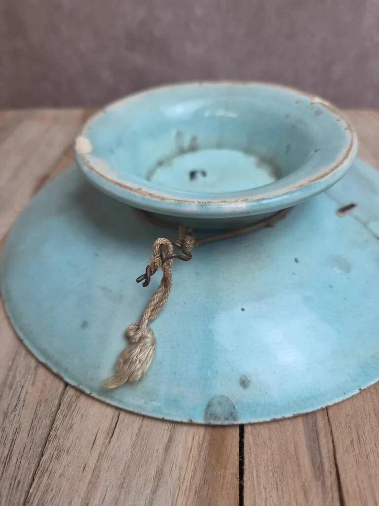 Old small compote dish in turquoise majolica with raised floral decoration.
