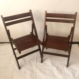 Pair of folding chairs in dark wooden slats
