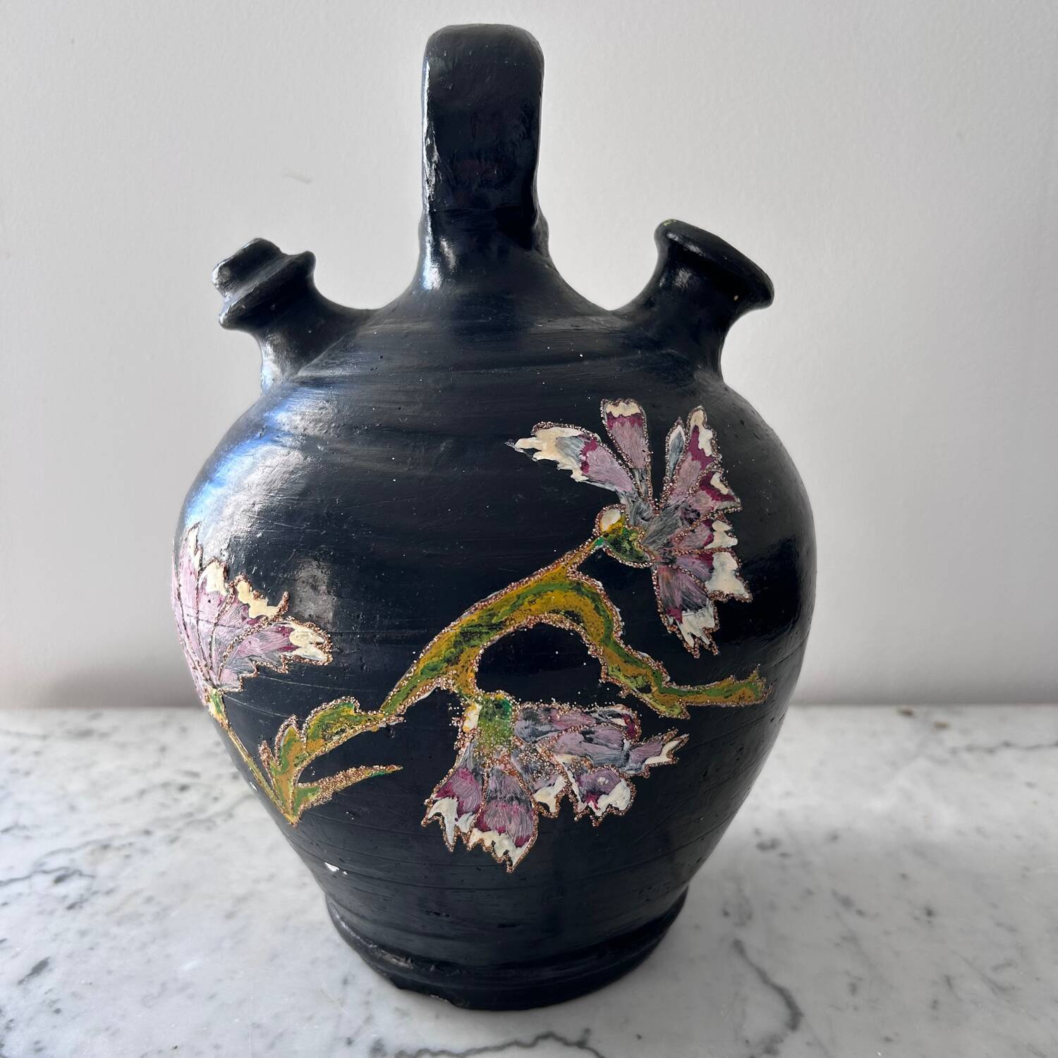 Black water jug with floral decoration