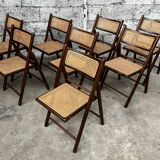 Serie de 8 chaises pliantes vintage en bois et cannage 1960