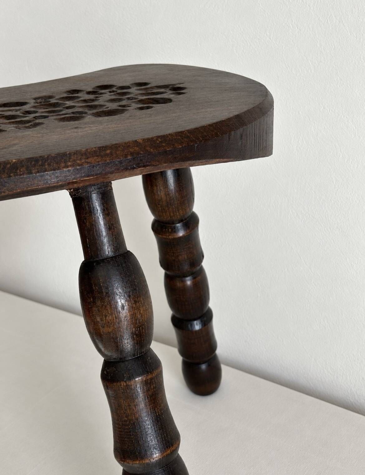 Restored dark wood tripod stool, bobbin leg, elegant furniture.