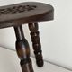 Restored dark wood tripod stool, bobbin leg, elegant furniture.