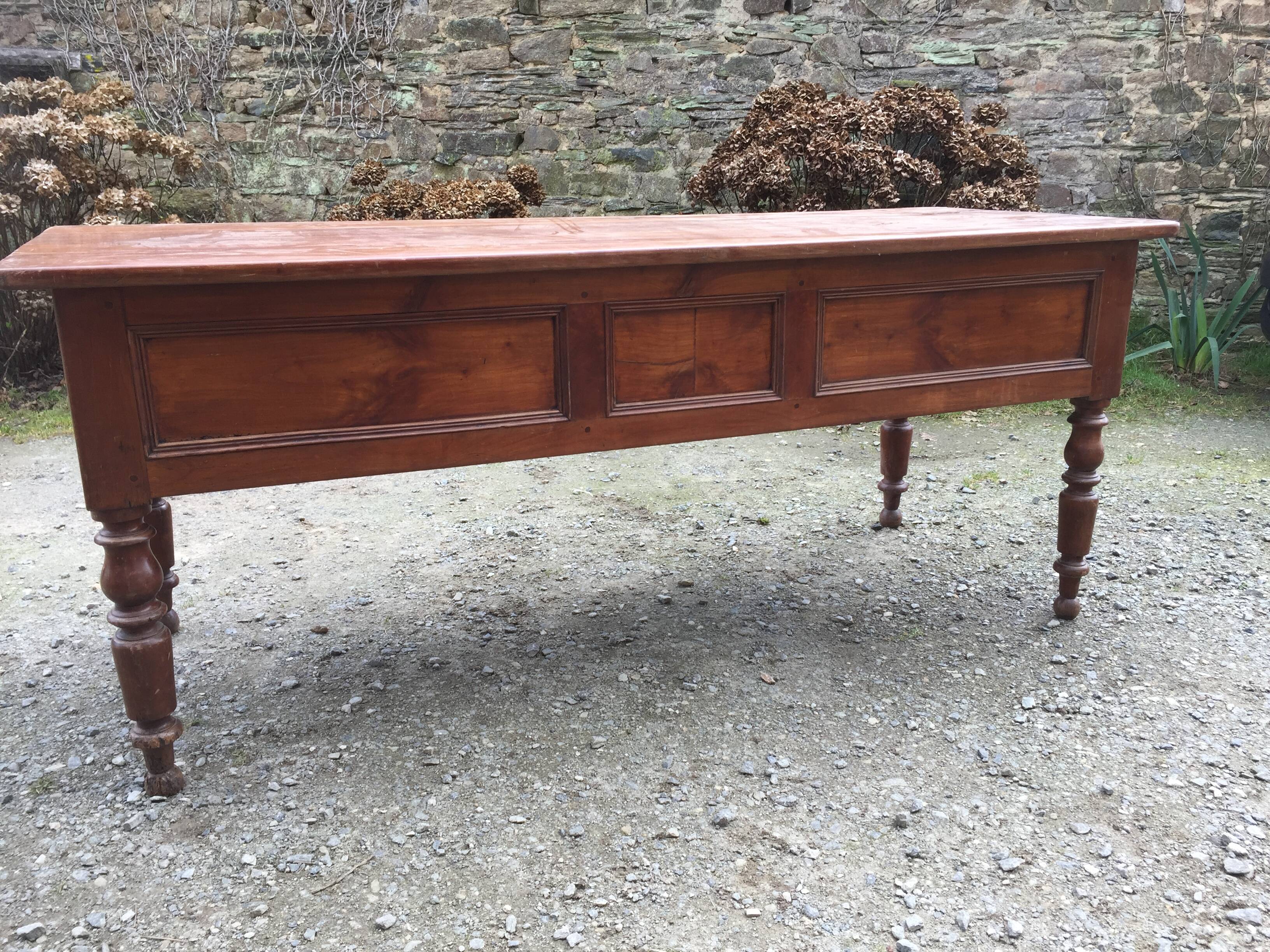 Old farmhouse table with cherry and chestnut panels with 3 drawers.