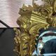 Beveled mirror in gilt bronze