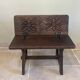 Small antique wooden bench with a folding backrest.