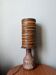 Table lamp with terracotta base and resin shade.