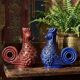 Pair of ceramic glazed candlesticks in the shape of roosters, signed A.G Roger, year 1948.