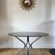 Set consisting of a table in chrome and smoked glass and its 4 tubular chairs in chrome and skaï a
