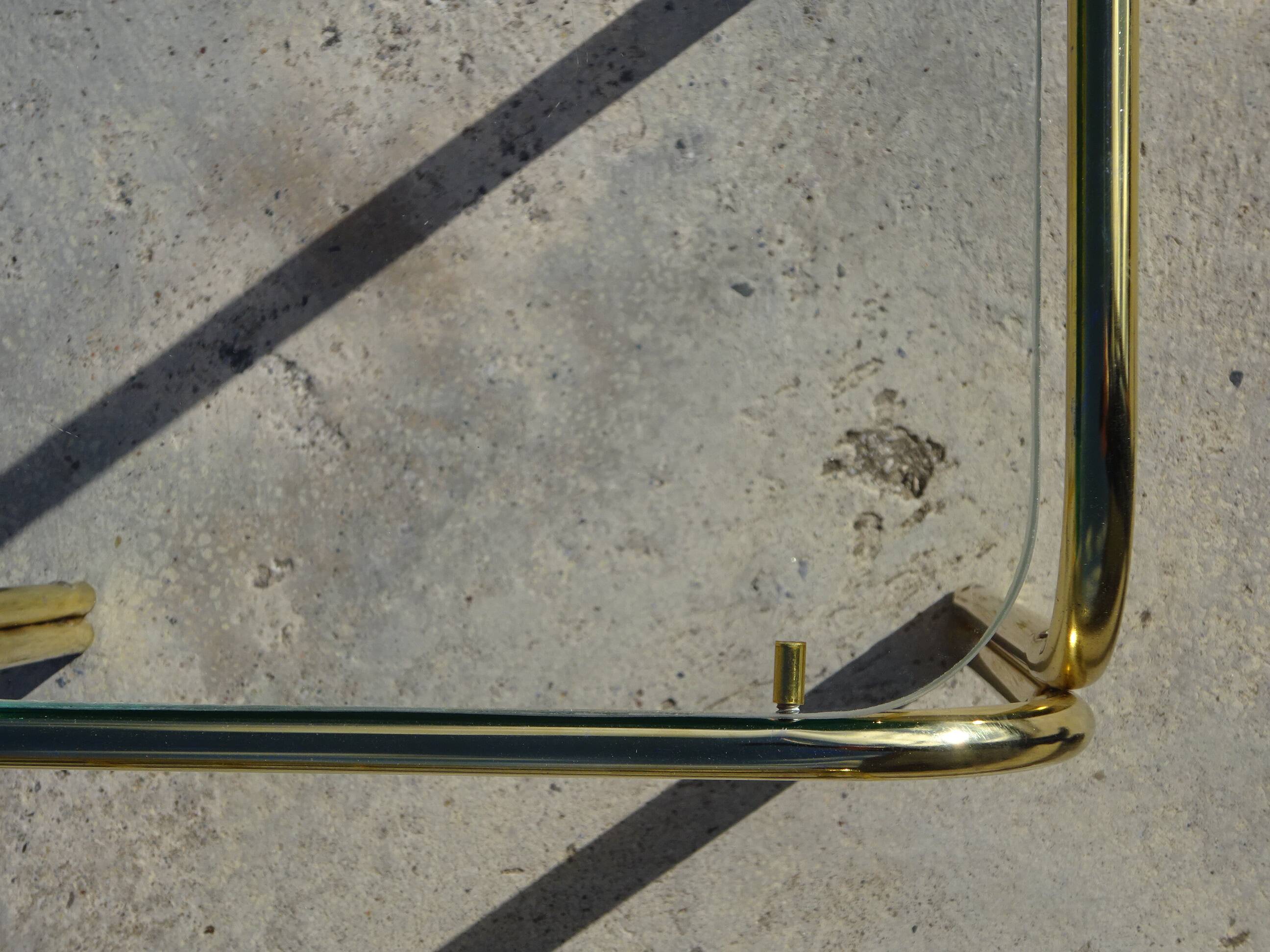 Nested tubular tables in gold metal.