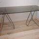 Smoked glass desk on tubular chrome trestles, 1970s design.