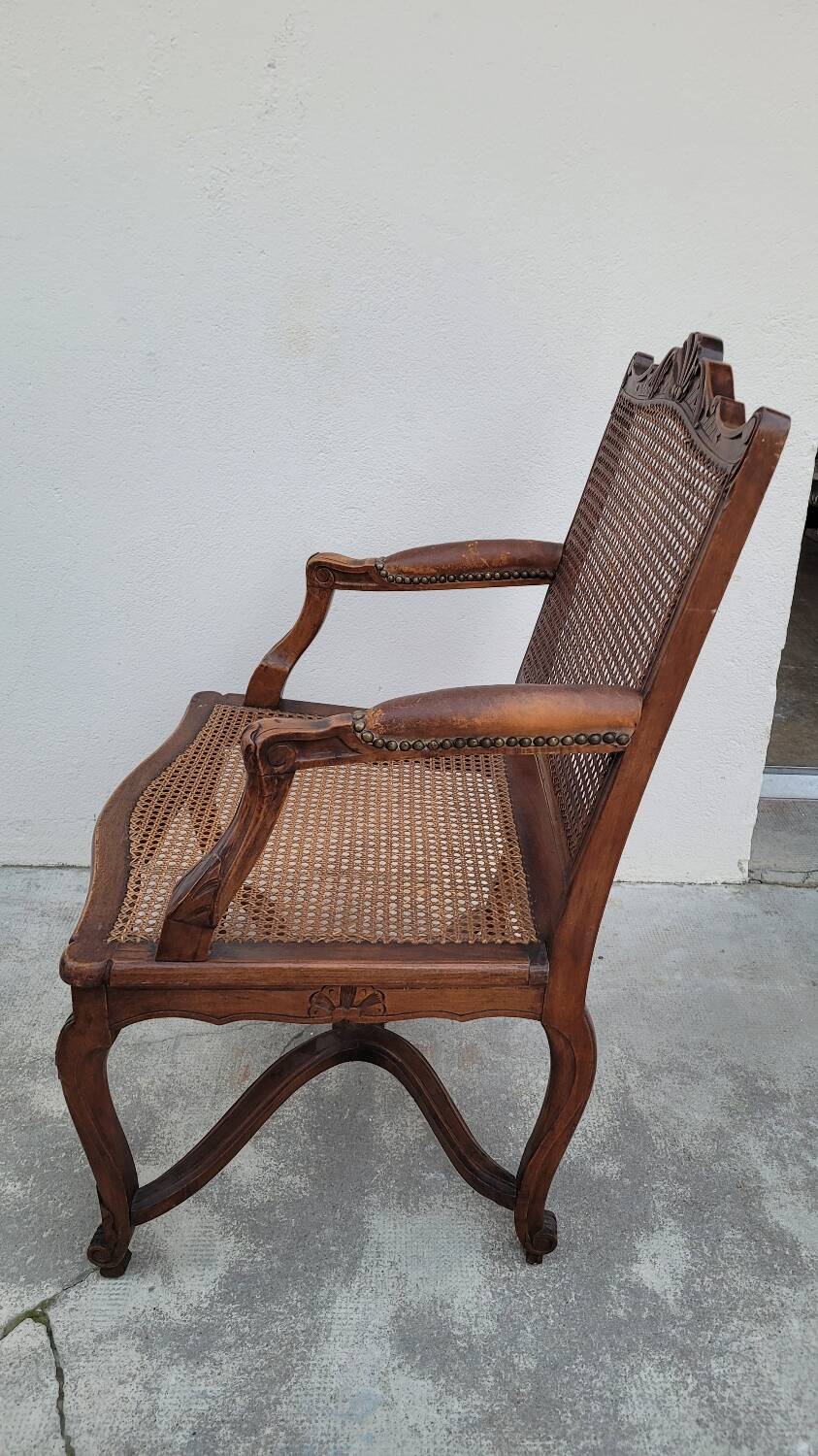 Louis XV Regency cane armchair leather armrests decorated with shell