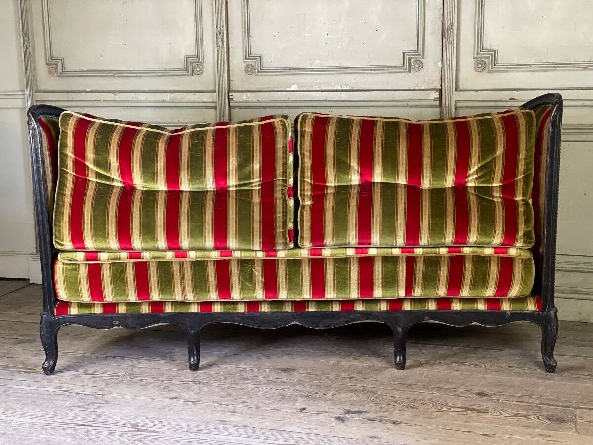 Louis XV style sofa in carved wood with a black patina