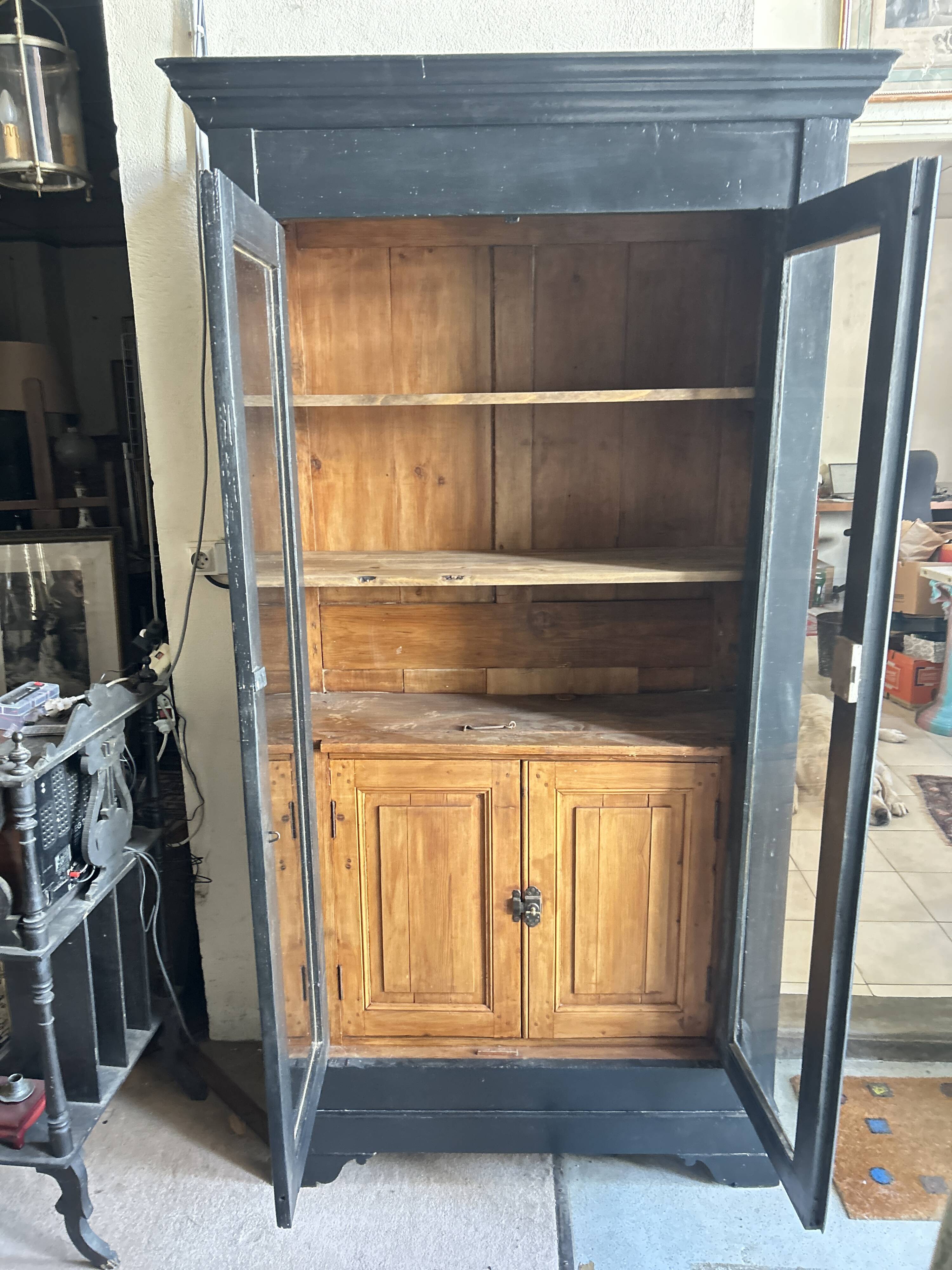 Black painted wardrobe with two glass doors and an interior sideboard.