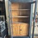 Black painted wardrobe with two glass doors and an interior sideboard.