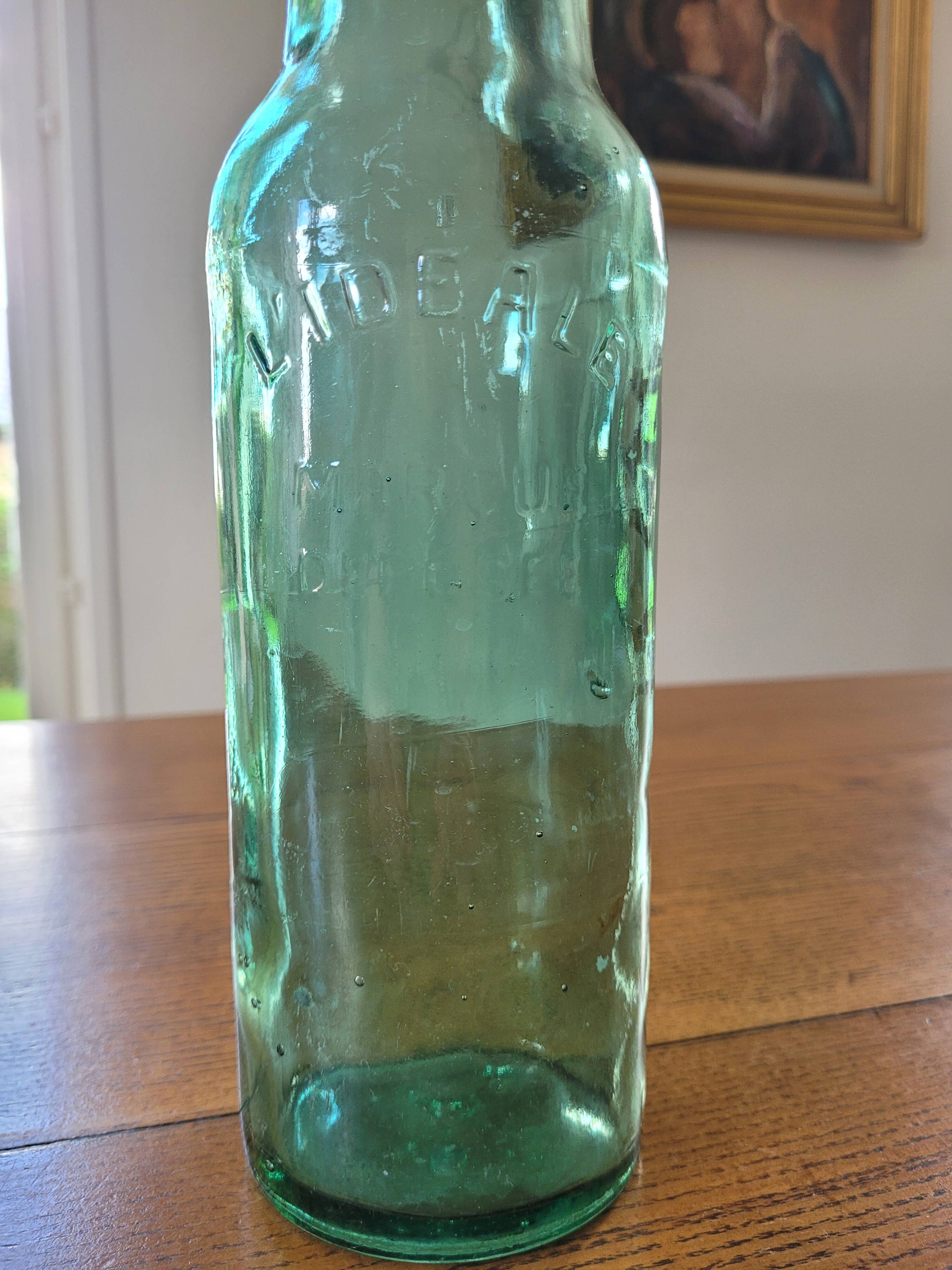 Vintage glass bottle l'Idéale with porcelain stopper