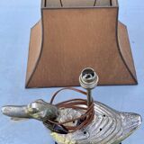 Old vintage lamp representing a duck in silver metal with wooden base