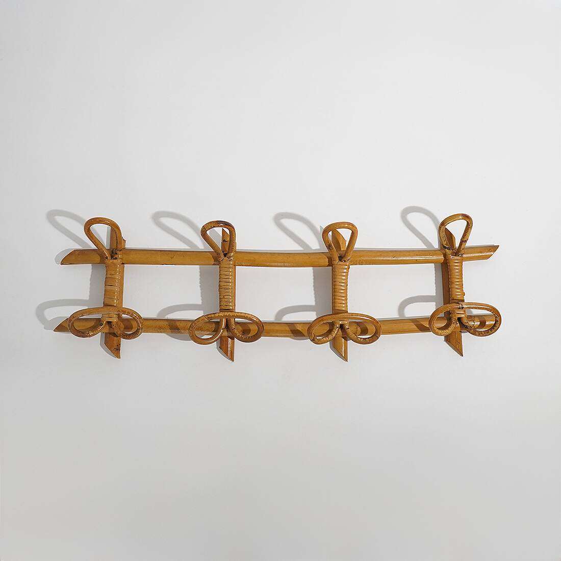 Wall coat rack in rattan and woven wicker, 1960s.