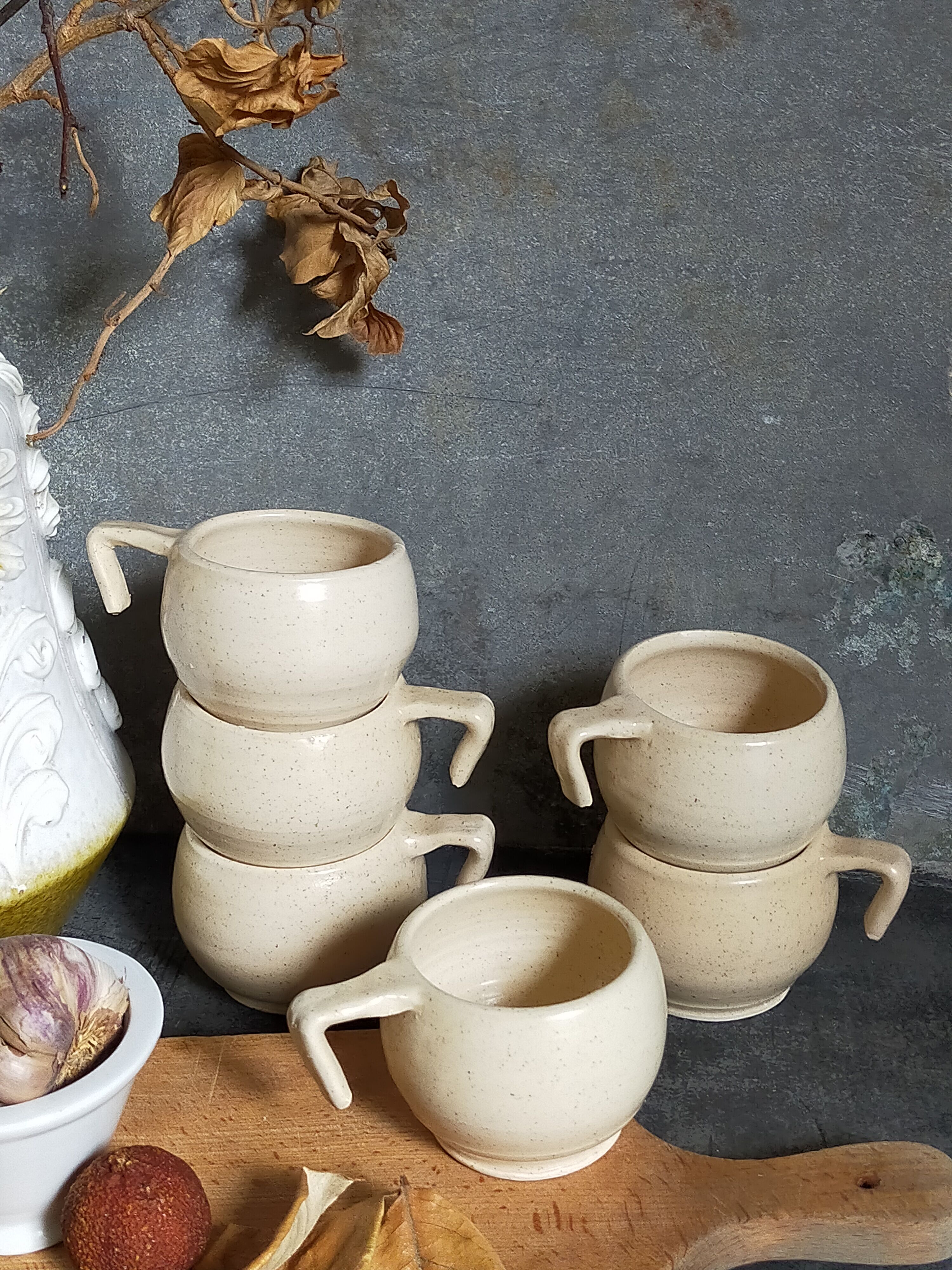 Six vintage potter's ceramic cups with vanilla enamel